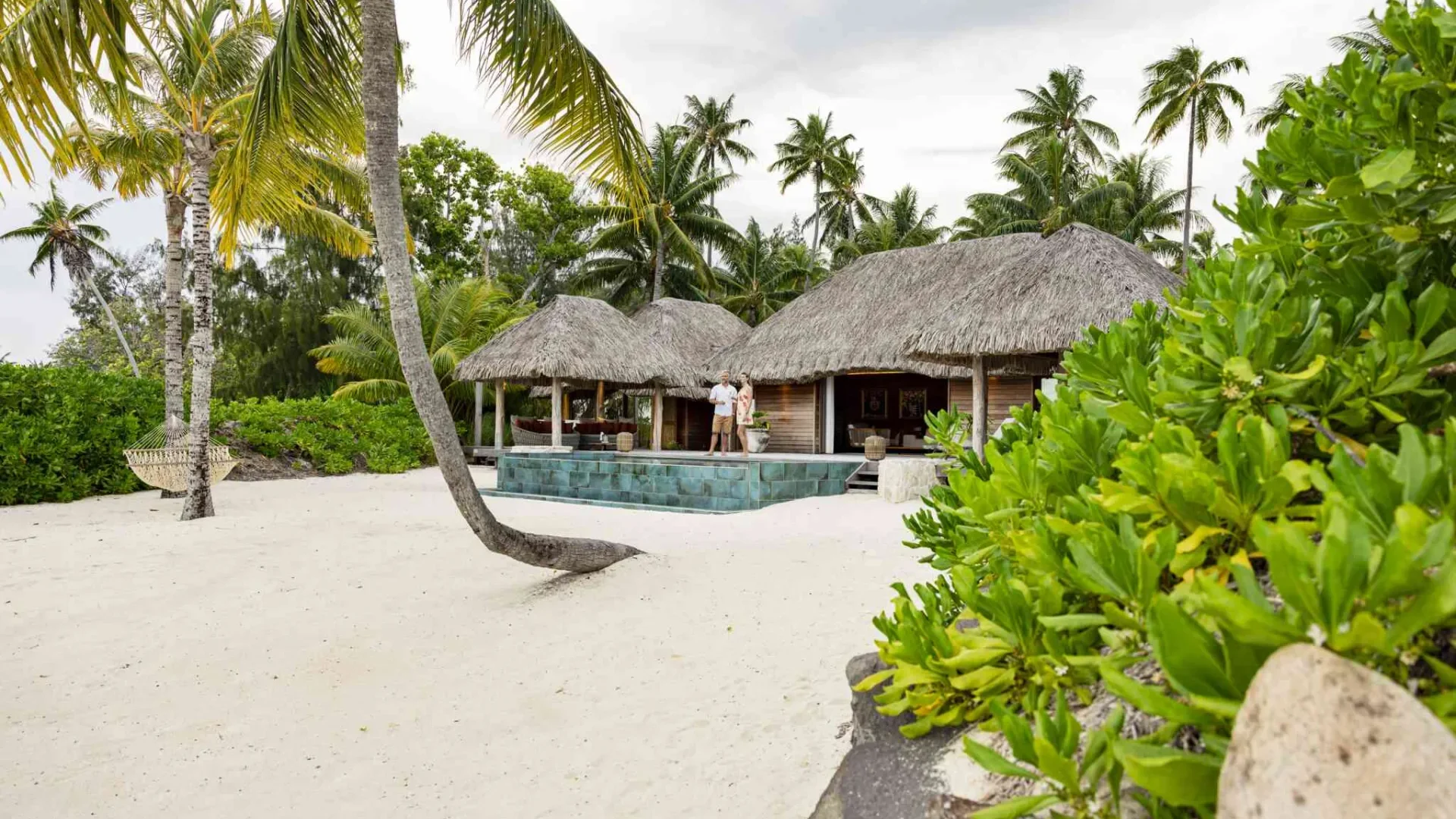 Couple at the Bora Bora by Pearl Resort with white sand beach © Grégoire Le Bacon