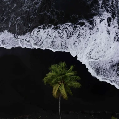 Volcanic Black sand beach in The Islands of Tahiti located on the east coast of the island© Jim Winter